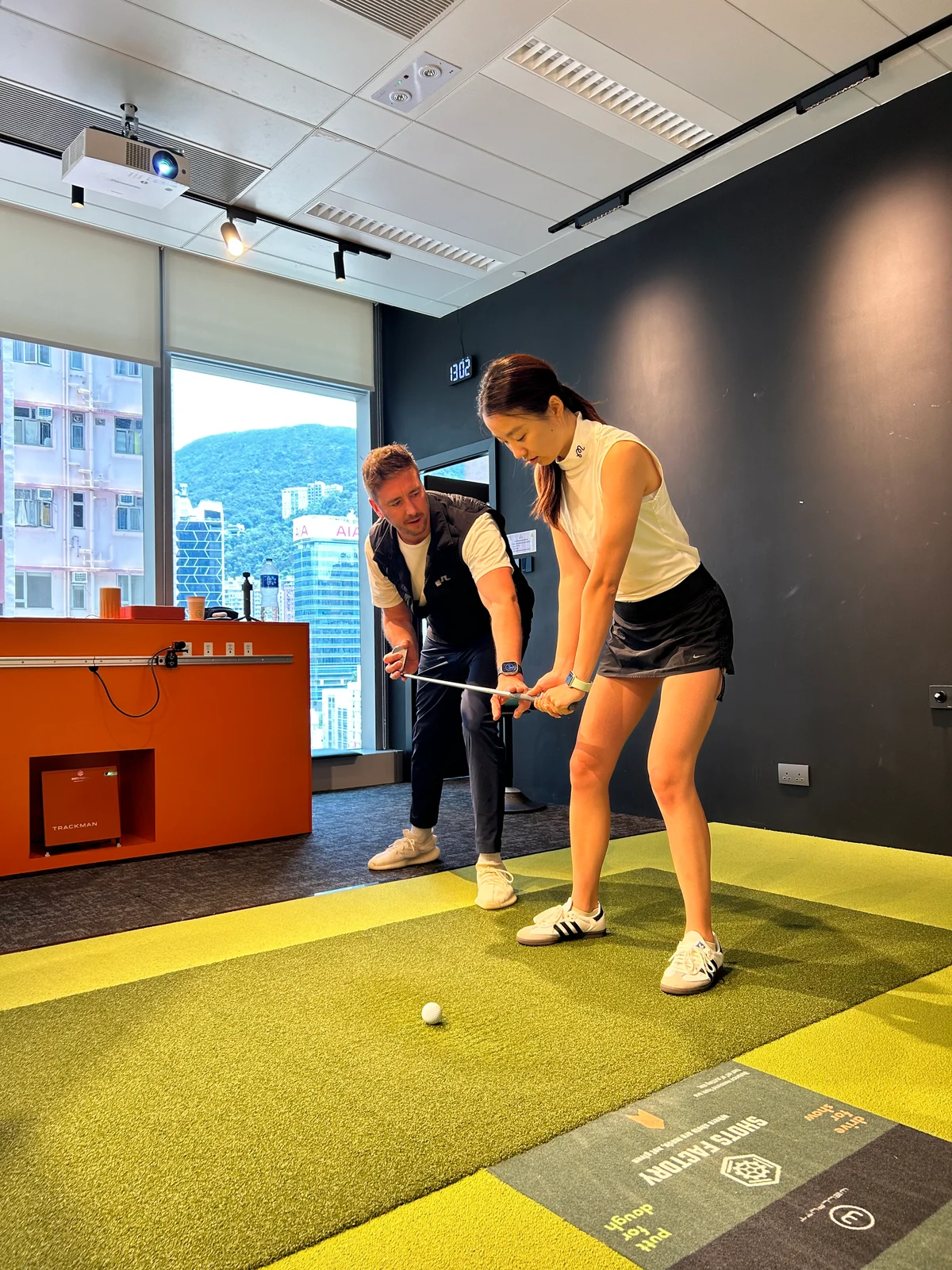 Mike coaching a golfer at Shots Factory Wanchai